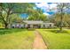 Charming single-story home featuring a large front yard, mature trees and inviting curb appeal at 20 Stone Gate S, Longwood, FL 32779