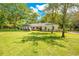 Inviting single-story home boasts lush lawn, mature trees, and a well-maintained landscape at 20 Stone Gate S, Longwood, FL 32779