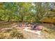 Inviting outdoor firepit area with chairs, perfect for entertaining surrounded by mature trees and a wooden fence at 20 Stone Gate S, Longwood, FL 32779