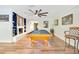 Game room features a pool table, bar seating, fireplace, built-in shelves, and wood flooring, creating a fun, inviting space at 20 Stone Gate S, Longwood, FL 32779