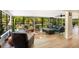 Bright living room featuring hardwood floors, large windows with outdoor views and comfortable seating arrangements at 20 Stone Gate S, Longwood, FL 32779