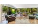 Bright living room featuring hardwood floors, large windows with outdoor views and comfortable seating arrangements at 20 Stone Gate S, Longwood, FL 32779