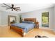 Spacious main bedroom featuring hardwood floors, a ceiling fan, and a large mirror on the wall at 20 Stone Gate S, Longwood, FL 32779