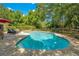 Backyard pool surrounded by a brick patio, lounge chairs, and privacy fencing at 20 Stone Gate S, Longwood, FL 32779