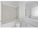 Bright bathroom with tiled shower-tub, modern vanity, and a large mirror creates a comfortable space at 2030 Firethorn Loop, Haines City, FL 33844