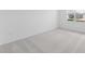 Clean, carpeted bedroom with a large window providing natural light at 2030 Firethorn Loop, Haines City, FL 33844