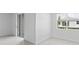 Bright, empty bedroom featuring tile floors, a sliding glass door to the backyard, and a window at 2030 Firethorn Loop, Haines City, FL 33844