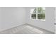 Bright bedroom features neutral carpet, fresh white paint, and natural light from a large window at 2030 Firethorn Loop, Haines City, FL 33844