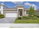 Charming single-story home with a well-manicured lawn, paver driveway, and inviting front entrance at 2030 Firethorn Loop, Haines City, FL 33844