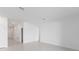 Bright living room with neutral walls and tile flooring. Hallway leads to the bedrooms at 2030 Firethorn Loop, Haines City, FL 33844