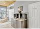 Entertaining wet bar area with storage and access to a powder room at 250 Shady Oaks Cir, Lake Mary, FL 32746