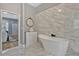 Bathroom with marble tile, soaking tub, and vanity at 250 Shady Oaks Cir, Lake Mary, FL 32746