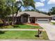 Beautiful brick home with mature trees, manicured lawn, and a two-car garage adding to its curb appeal at 250 Shady Oaks Cir, Lake Mary, FL 32746
