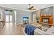Inviting living room with a cozy fireplace, hardwood floors, and a view of the front entry and double glass doors at 250 Shady Oaks Cir, Lake Mary, FL 32746