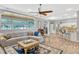 Comfortable living room featuring wood floors, large windows, and open floorplan to kitchen at 250 Shady Oaks Cir, Lake Mary, FL 32746