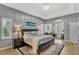 Comfortable main bedroom with tray ceiling, wood floors, and ensuite sitting area at 250 Shady Oaks Cir, Lake Mary, FL 32746