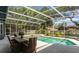 Outdoor dining set next to a screened-in pool at 250 Shady Oaks Cir, Lake Mary, FL 32746