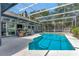 Screened pool with a dining table and seating in an outdoor patio at 250 Shady Oaks Cir, Lake Mary, FL 32746