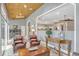 Sun room with wood ceiling, comfortable seating, and entry to interior kitchen at 250 Shady Oaks Cir, Lake Mary, FL 32746