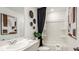 Bright bathroom featuring neutral colors, a tub-shower combo, and decorative wall art at 2572 Penguin Blvd, Davenport, FL 33837