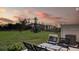 Outdoor patio space with chairs and a table overlooking a grassy area at 2576 Penguin Blvd, Davenport, FL 33837