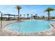 Community pool with zero entry, water features, shade and lounge seating at 2576 Penguin Blvd, Davenport, FL 33837