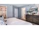 Comfortable bedroom with a walk-in closet, dresser, and neutral decor at 2584 Penguin Blvd, Davenport, FL 33837