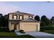 Charming home with a two-car garage, manicured lawn, and a welcoming front entrance at 2803 San Marco Way, Winter Haven, FL 33884