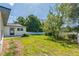 Large backyard with green grass, a privacy fence, and mature trees provide a secluded area at 2839 Tamarack Trl, Apopka, FL 32703