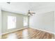 Bright bedroom with wood-look floors and two windows, offering ample natural light at 2839 Tamarack Trl, Apopka, FL 32703