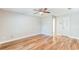 This bedroom offers ample space with hardwood floors, a ceiling fan, and a double closet at 2839 Tamarack Trl, Apopka, FL 32703