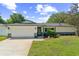 Charming single-story home with a well-manicured lawn, a two-car garage and inviting front entrance at 2839 Tamarack Trl, Apopka, FL 32703