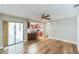 Spacious living room with hardwood floors adjacent to the kitchen and access to the patio through sliding glass doors at 2839 Tamarack Trl, Apopka, FL 32703