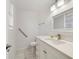 Well-lit bathroom featuring a vanity with a white countertop, neutral paint, and tile floors, offering a clean aesthetic at 30 Sunset Cir, Lake Alfred, FL 33850