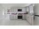 Beautiful kitchen with gray cabinets, stainless steel appliances, modern countertops, and stylish backsplash at 30 Sunset Cir, Lake Alfred, FL 33850