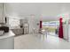 Spacious kitchen and dining area with stainless steel appliances, tile flooring, and sliding glass door to screened porch at 30 Sunset Cir, Lake Alfred, FL 33850