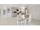 Bright kitchen featuring gray cabinets, stainless appliances, and tile floors; a table with chairs is at the forefront at 30 Sunset Cir, Lake Alfred, FL 33850