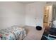 Bright bedroom with a toy vehicle-themed bedspread, with a door to the right leading to the bathroom at 3020 Water Sprite St, Orlando, FL 32808