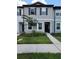 Charming townhome features neutral siding, a well-manicured lawn, and a welcoming entrance for easy access at 3020 Water Sprite St, Orlando, FL 32808