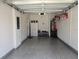 Spacious garage with epoxy flooring, built-in storage, and a water heater at 3020 Water Sprite St, Orlando, FL 32808