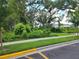 Lush green space near a sidewalk with bike racks and a few houses in the background partially obscured by trees at 3020 Water Sprite St, Orlando, FL 32808