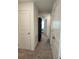 Hallway with neutral tones, doors leading to various rooms, and a built-in bookcase at 3020 Water Sprite St, Orlando, FL 32808
