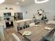 Modern kitchen with stainless steel appliances, a center island, and a dining area ideal for cooking and entertaining at 3020 Water Sprite St, Orlando, FL 32808