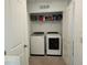 Laundry room with a front-load washer and dryer, and shelving above at 3020 Water Sprite St, Orlando, FL 32808
