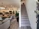 Inviting open-concept living area with modern kitchen, dining space, and staircase at 3020 Water Sprite St, Orlando, FL 32808