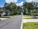 Neighborhood street lined with townhomes and mature trees, creating a tranquil atmosphere at 3020 Water Sprite St, Orlando, FL 32808