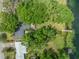 Aerial view of a home with a private dock and lush landscaping along the waterfront at 3225 Hargill Dr, Orlando, FL 32806