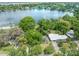 Stunning aerial view of a lakeside home surrounded by lush greenery and showcasing its proximity to a serene lake at 3225 Hargill Dr, Orlando, FL 32806