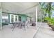 A covered back patio with stylish outdoor furniture and peaceful scenery at 3225 Hargill Dr, Orlando, FL 32806