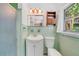 Classic bathroom with original green tile, vanity sink, and shower at 3225 Hargill Dr, Orlando, FL 32806